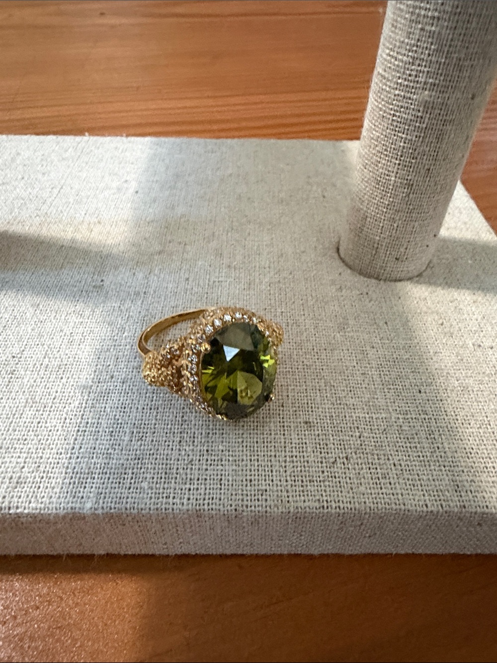 Goldtone Ring with Olive Green Oval Center and Clear Rhinestones, 7 3/4